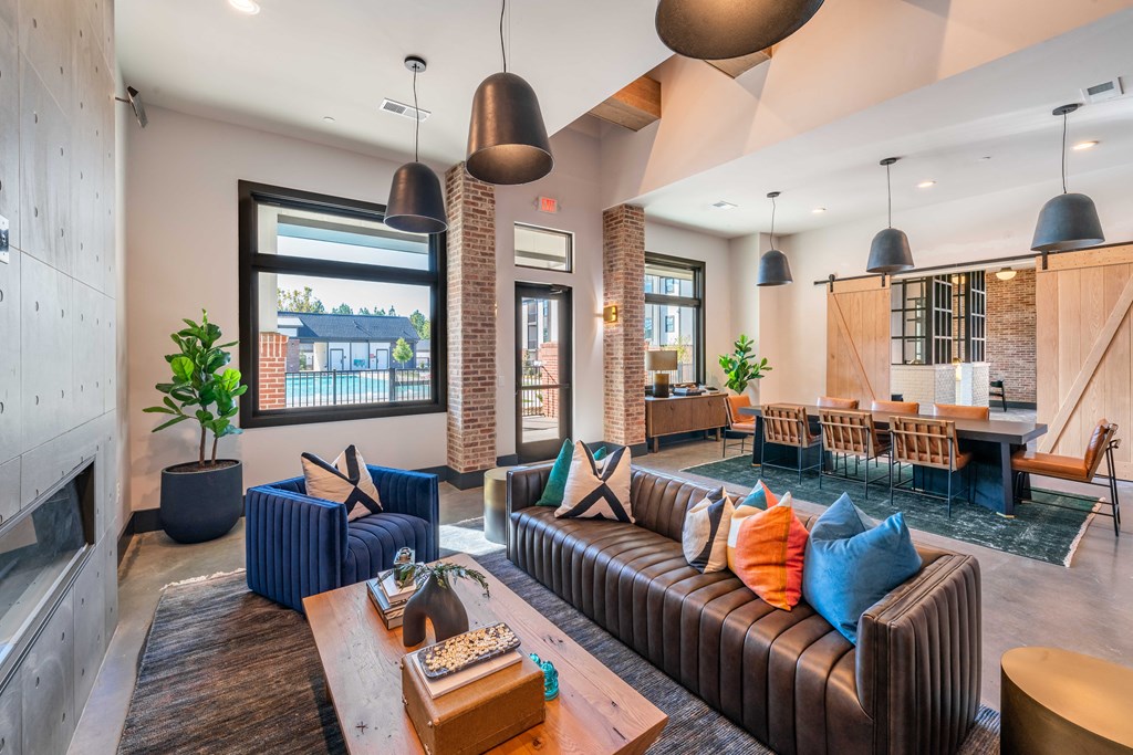 a living room with couches and chairs and a fireplace