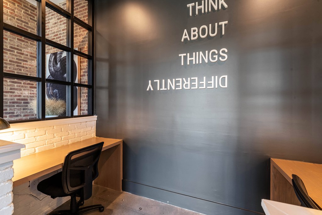 a room with a desk and a window with the words think about things and a