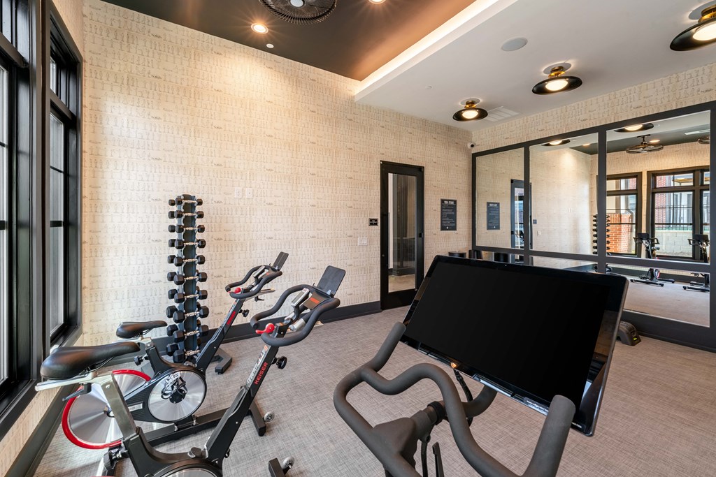 a home gym with weights and a tv