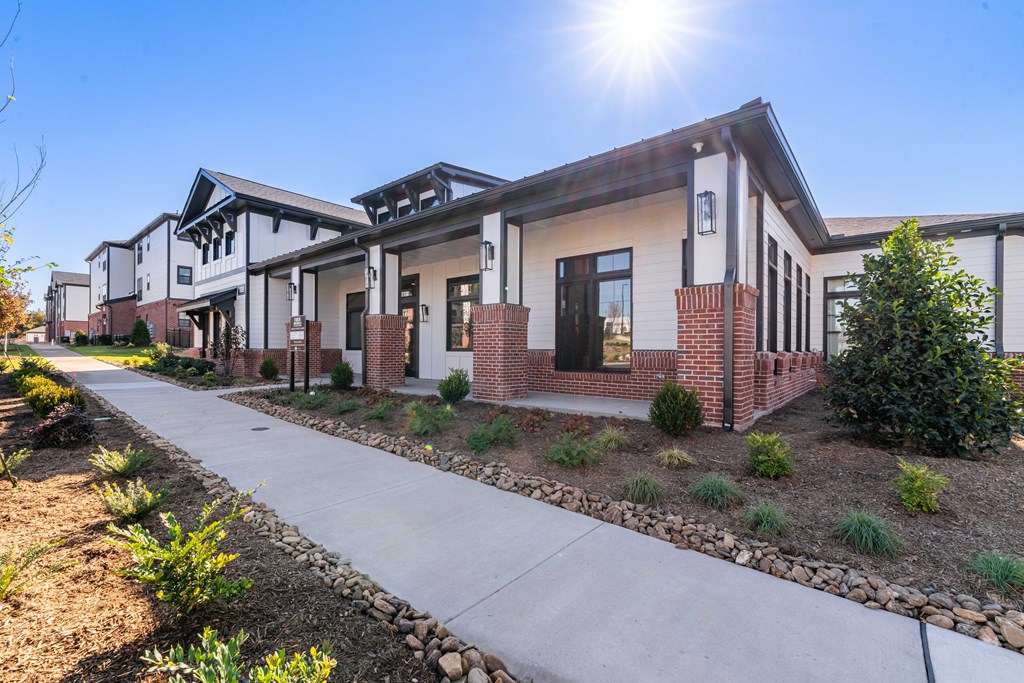 a row of houses with a sidewalk in front of them