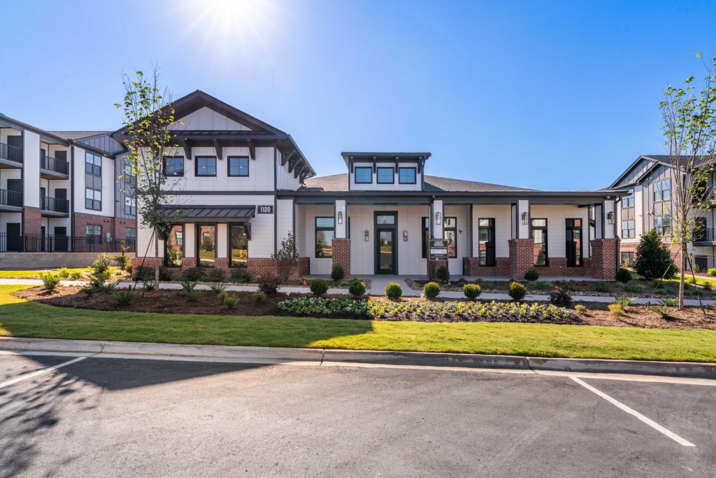 a large house with a lawn and a parking lot