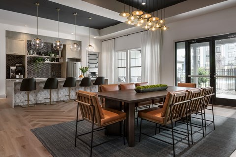 A modern dining room with a large table and chairs.