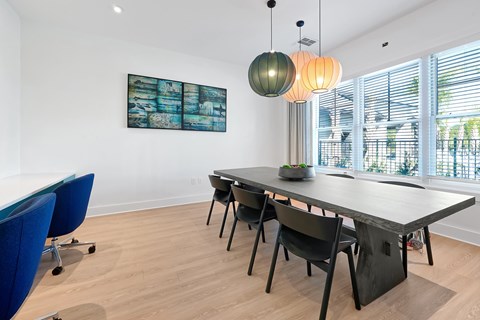 A conference room with a long table and chairs.