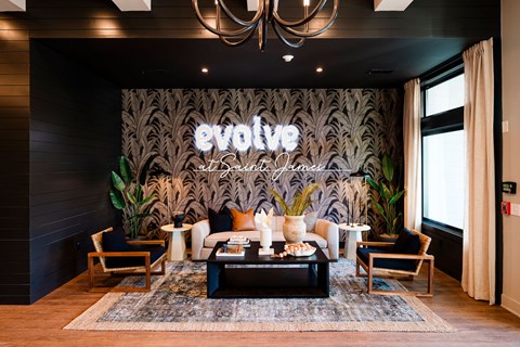A living room with a large couch and a sign that says "evolve".