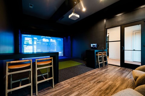 A room with a bar and a television.