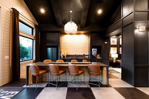 A modern dining room with a large table and chairs.