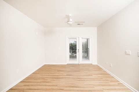 A room with a sliding door and a ceiling fan.