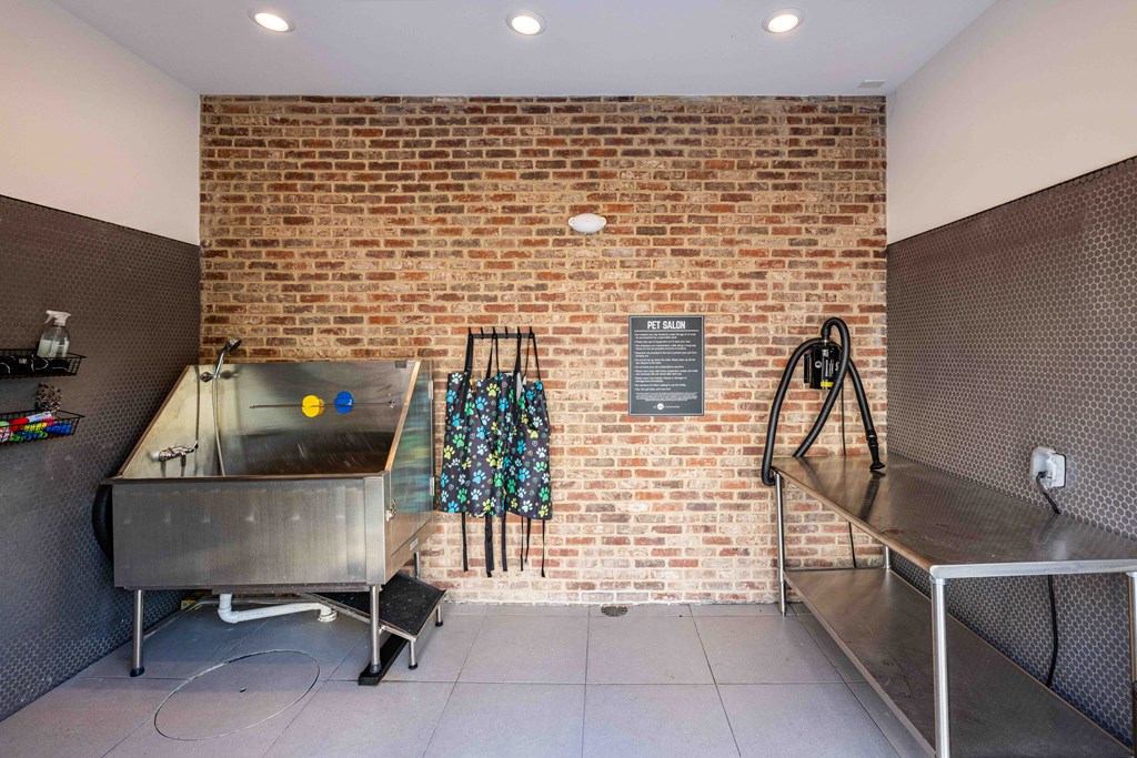 A brick wall with a plaque and a metal table.