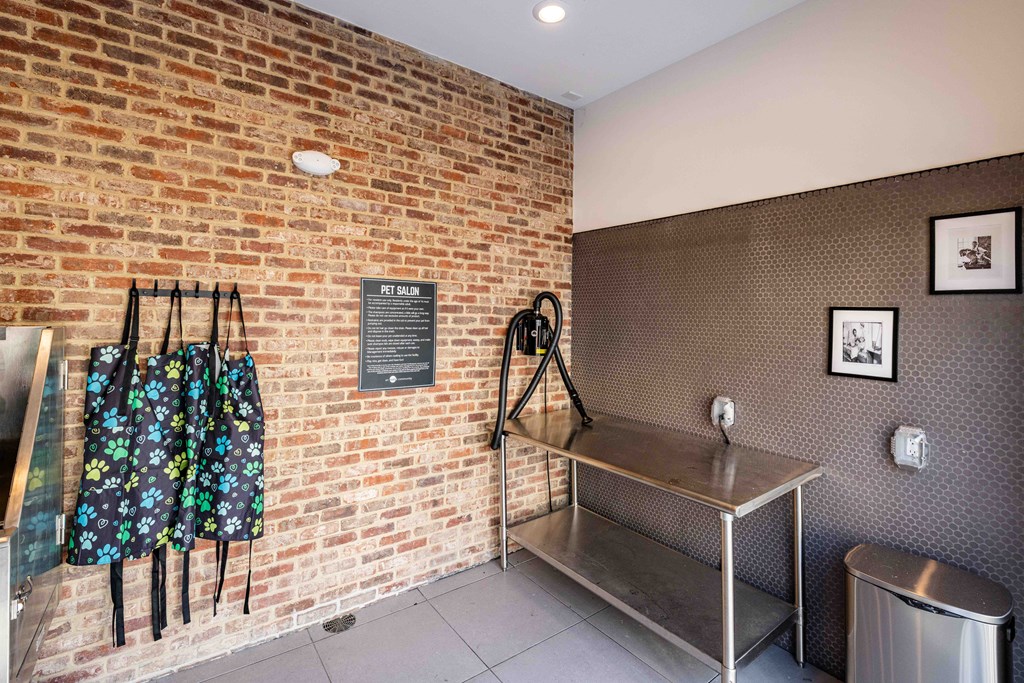 A room with a brick wall and a metal table.