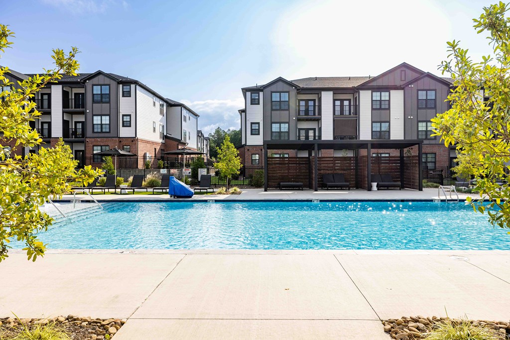 A pool in front of apartment buildings.