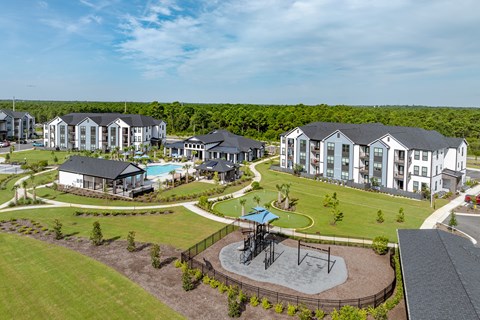 Overview drone photo of the complex with a playground pool and golf.