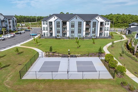 Overview of the tennis courts located from sidewalks to the buildings.