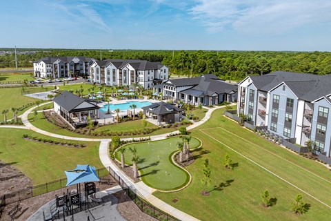 Drone photo of the property with pool, golf course and playground.