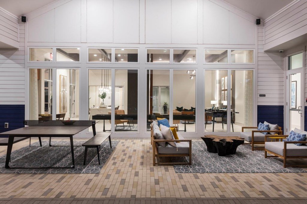 a large living room with a wooden floor and glass doors