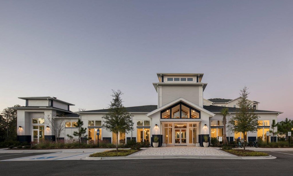 the exterior of a building at night with its doors open
