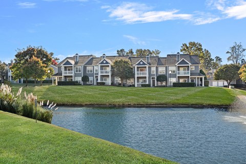 A row of apartment buildings with a body of water in front at Hawthorne Bridford in Greensboro, NC.