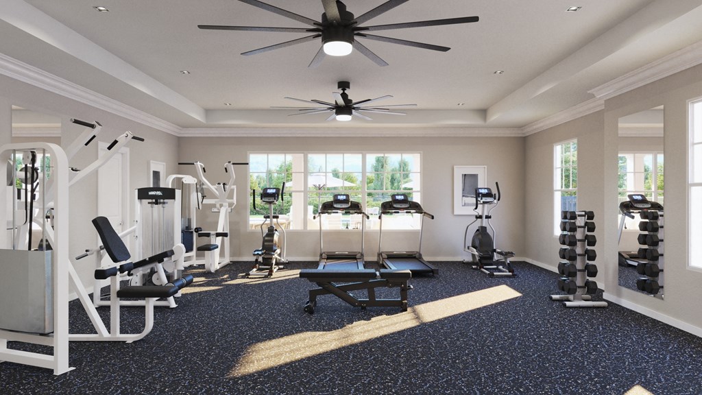 a gym with exercise equipment and a ceiling fan