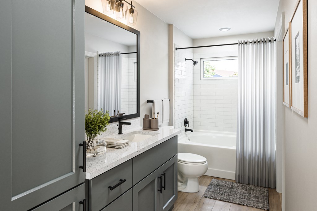 a bathroom with a shower toilet and sink and a mirror