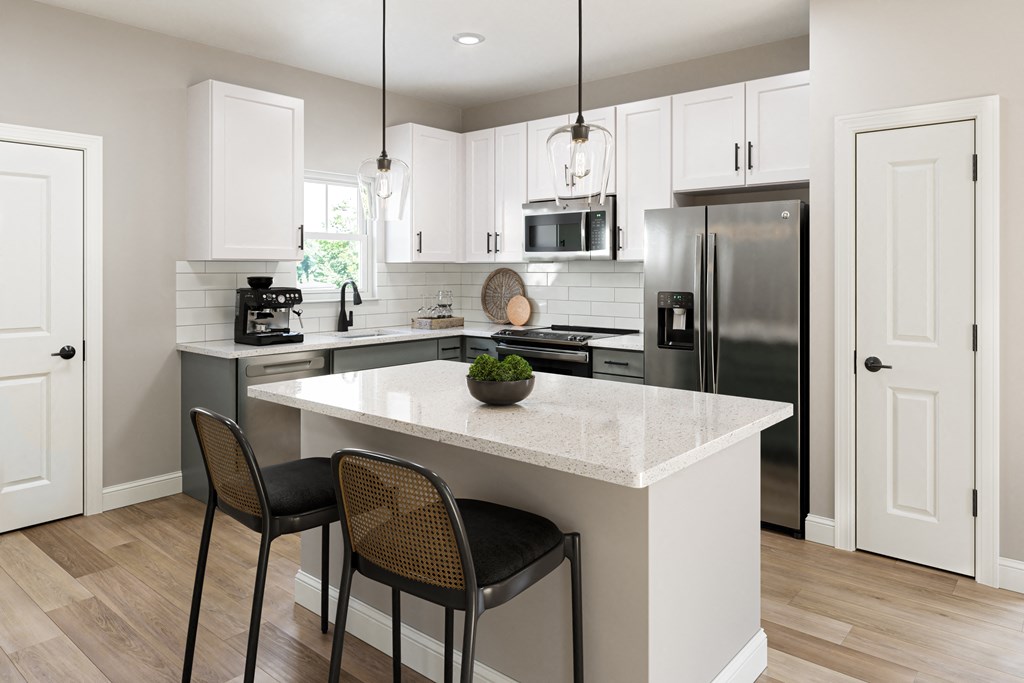 a kitchen with an island with two chairs and a refrigerator