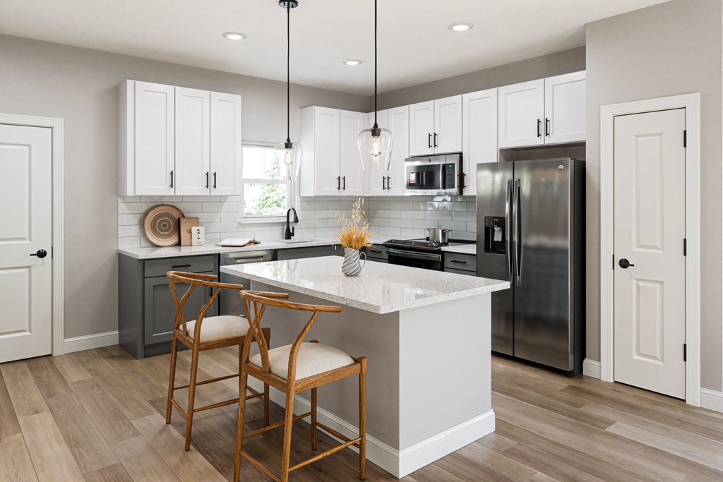a kitchen with a large island with two chairs