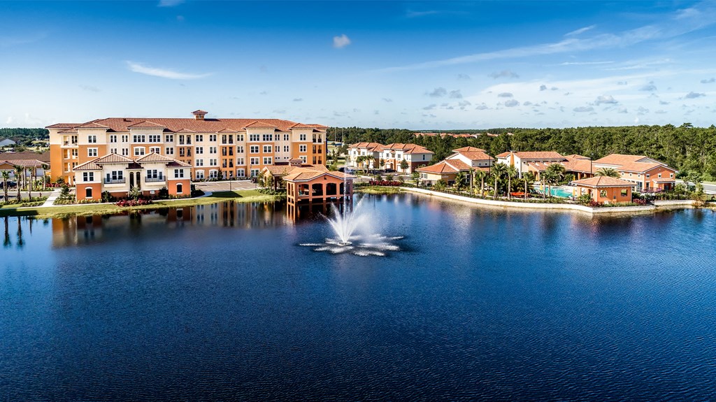 a fountain in the middle of the lake at the resort