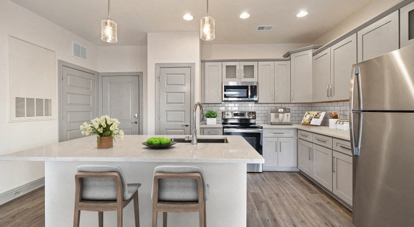 Modern Kitchen with Stainless Steel Appliances with White Granite Countertops and Light Grey Cabinets