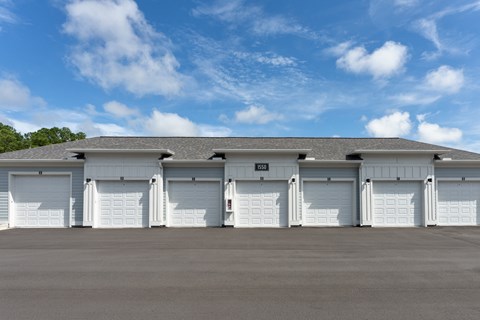 A garage  with a grey roof and white garage doors at Evolve Holly Ridge Apartments in Holly Ridge, NC.