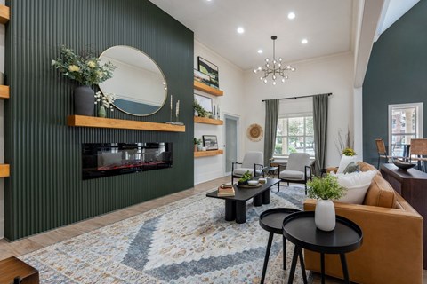 A living room with a fireplace and a rug on the floor.