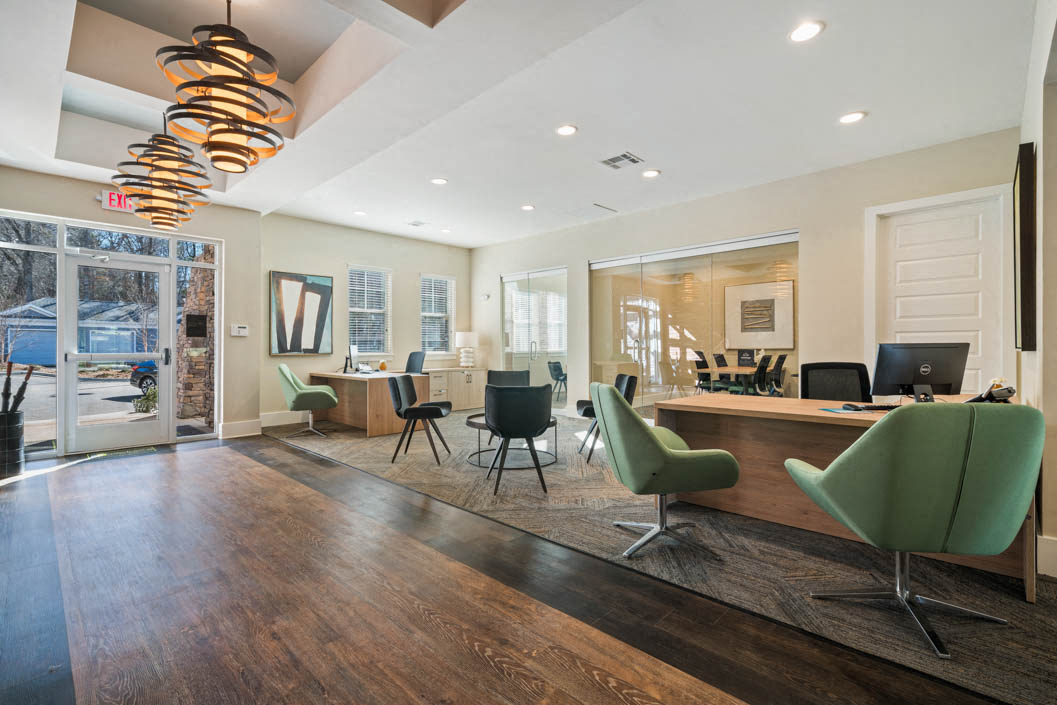 entrance to modern leasing office with desk and chairs