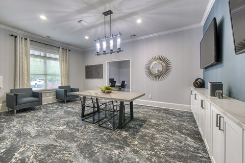 A dining room with a table and chairs.