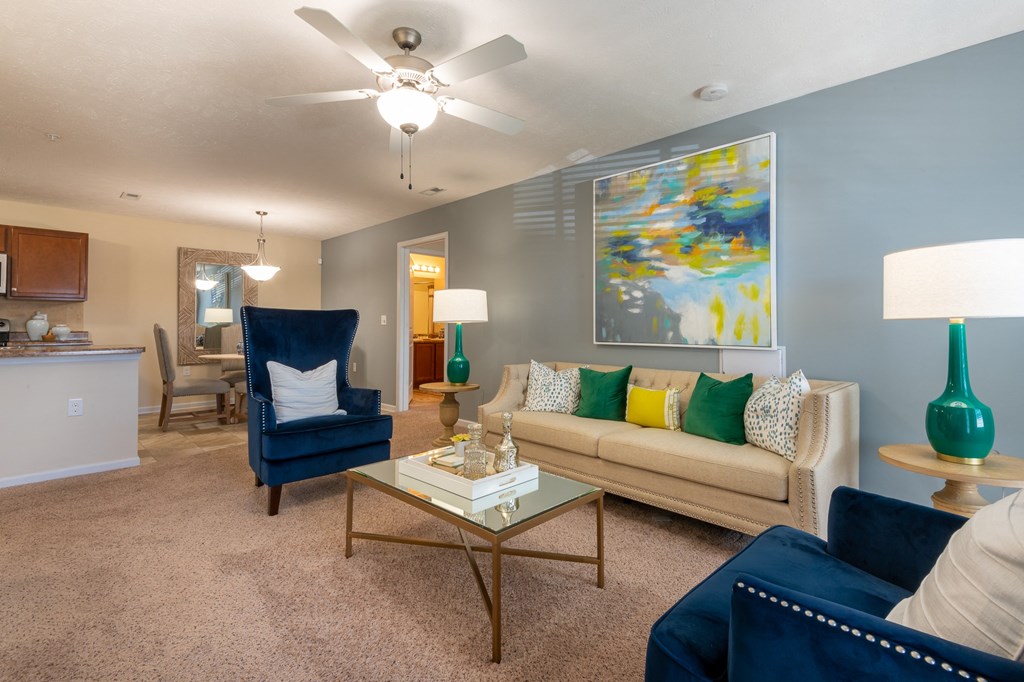 a living room with a ceiling fan and a couch
