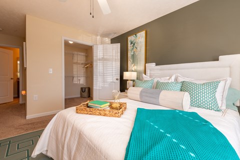 a bedroom with a white bed and a blue blanket