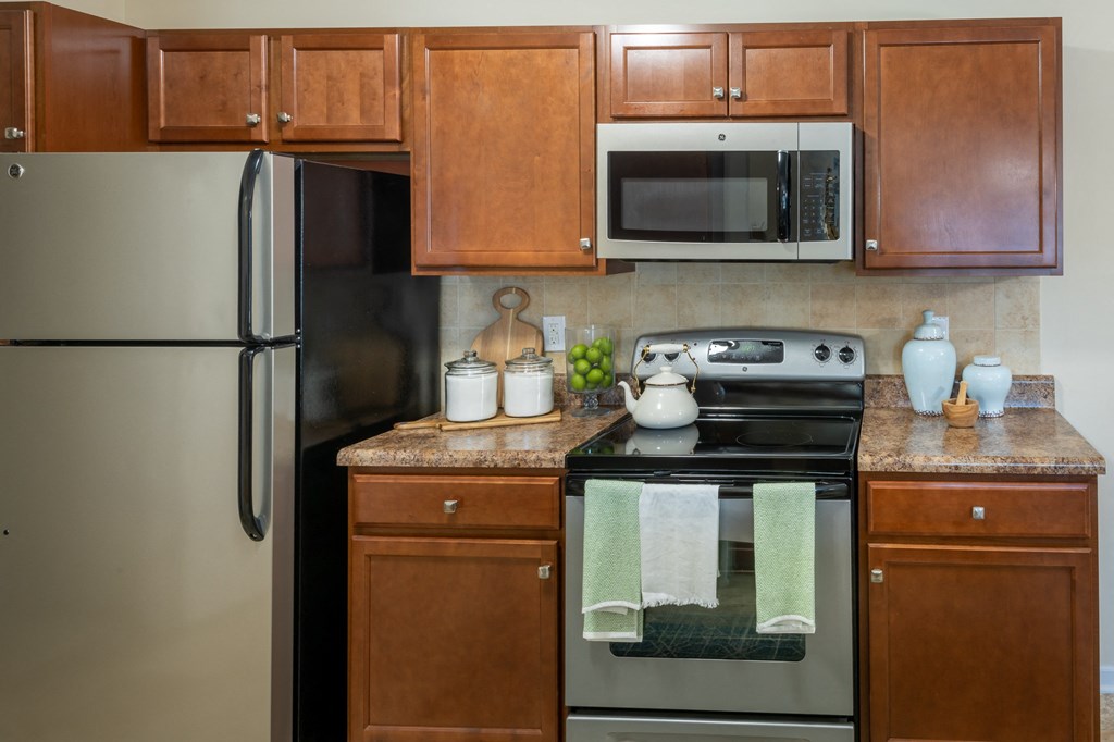 a kitchen with stainless steel appliances and wooden cabinets