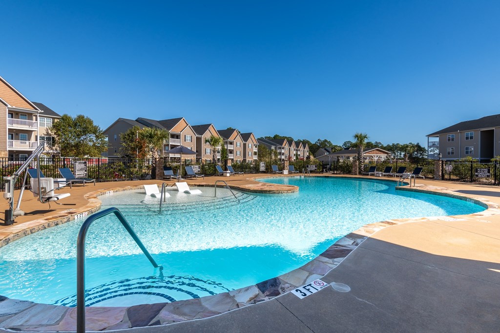 a swimming pool with apartments in the background