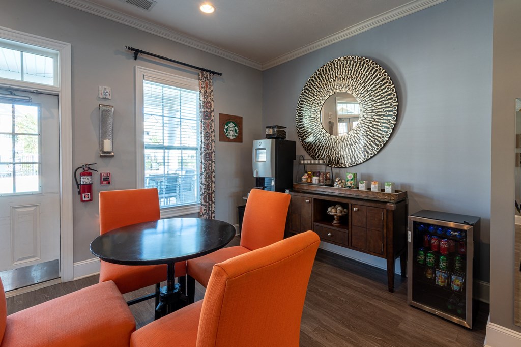 a living room with a table and chairs and a mirror