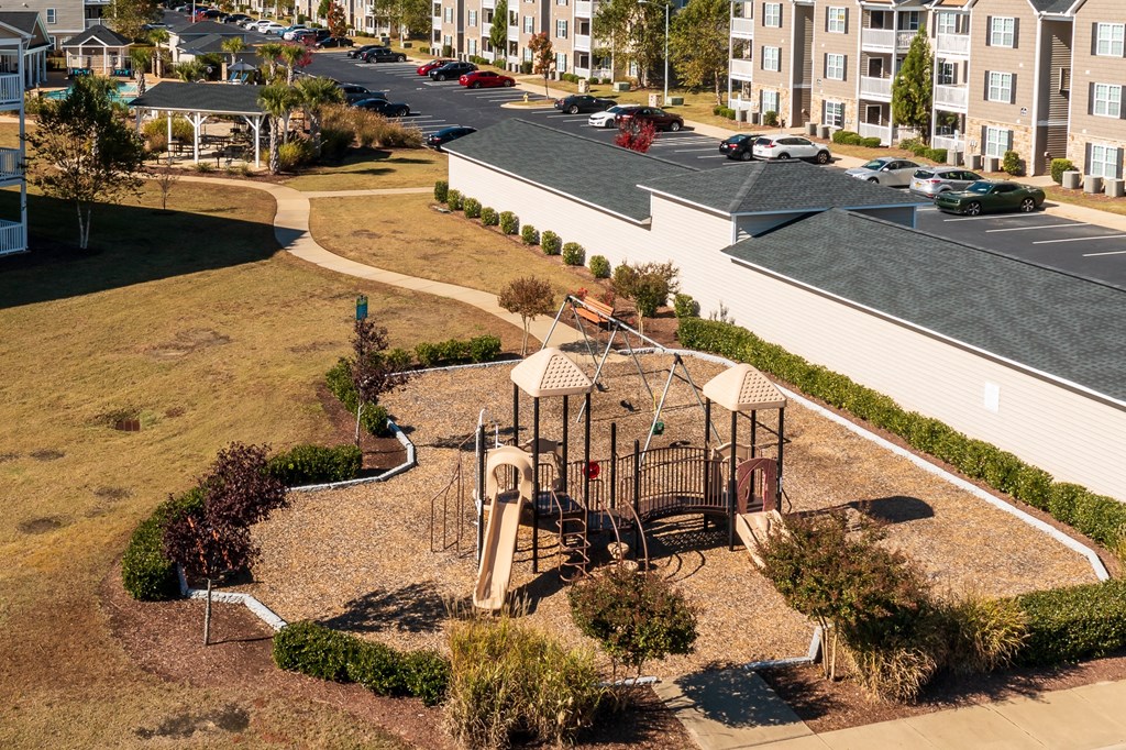 an aerial view of a playground in the middle of a park