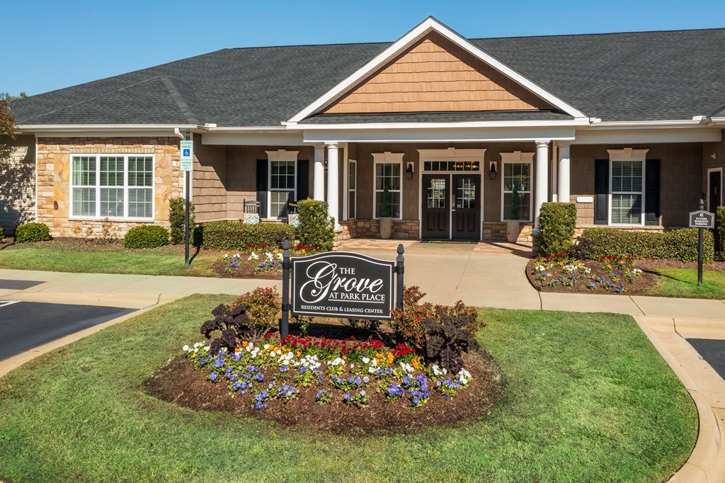 the square care center building with a sign in the front yard