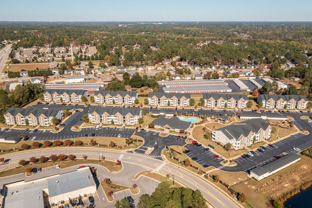 an aerial view of a parking lot and buildings in a city