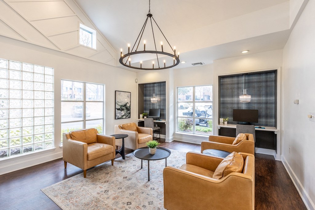 a living room with couches and chairs and a chandelier