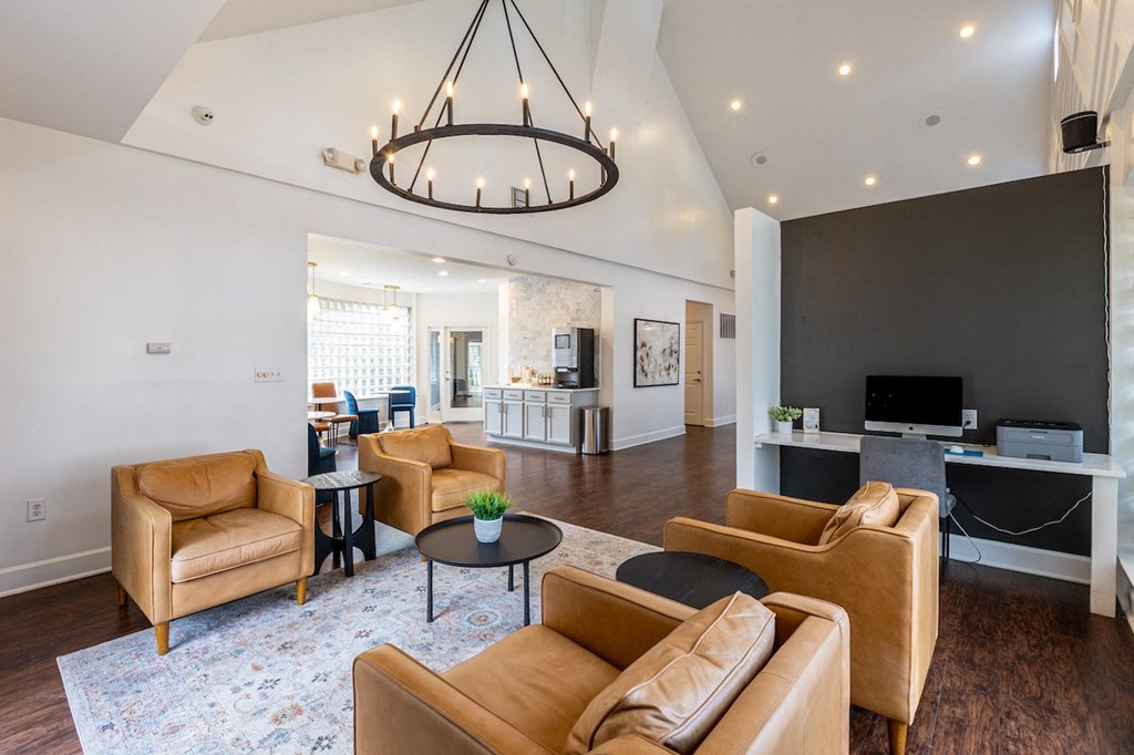 a living room with couches and chairs and a chandelier
