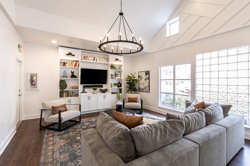 a living room with a gray couch and a tv
