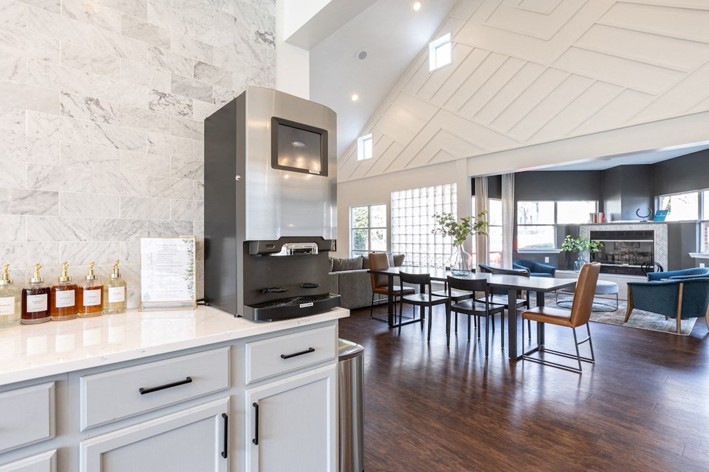 a kitchen with white cabinets and a table with chairs