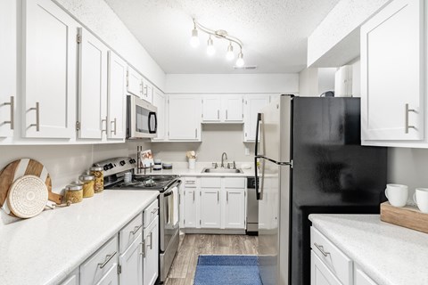 the preserve at ballantyne commons apartment kitchen with white cabinets and appliances