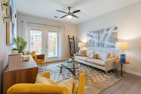 a living room with a couch and a ceiling fan