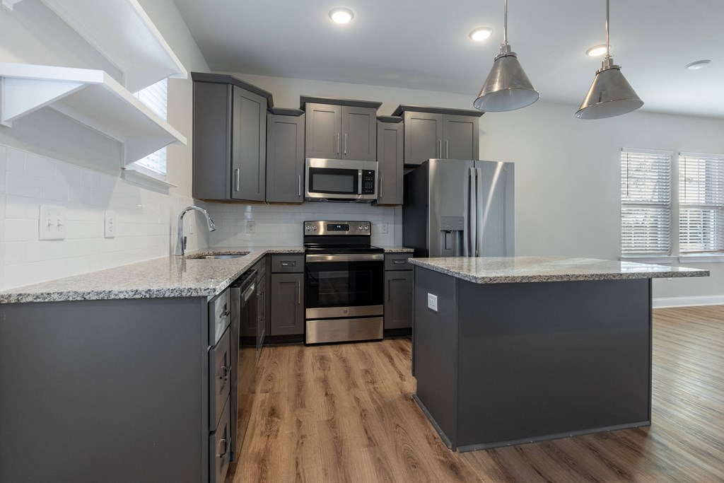 an open kitchen with granite counter tops and stainless steel appliances