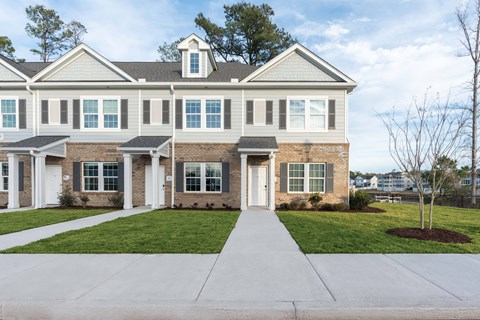a large house with a sidewalk in front of it