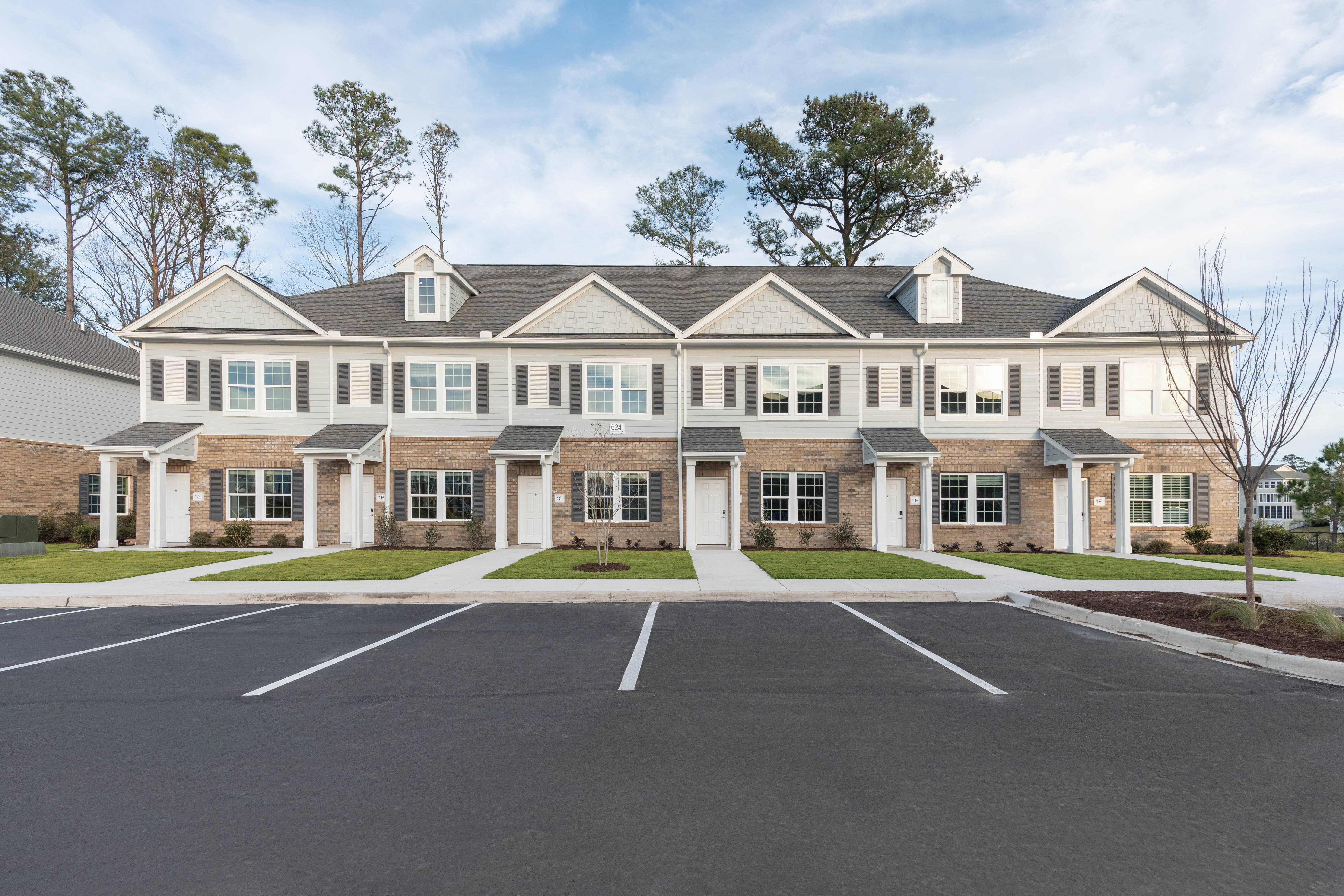 a large house with a parking lot in front of it