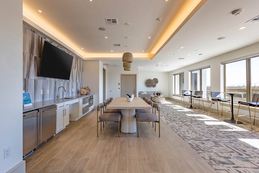 A modern kitchen with a dining table and chairs.