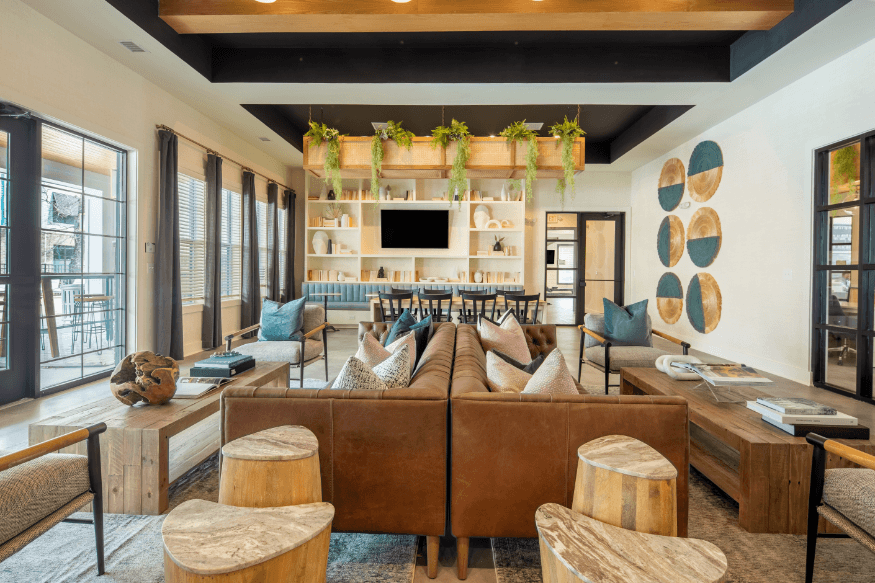 a living room with a large brown couch and a television