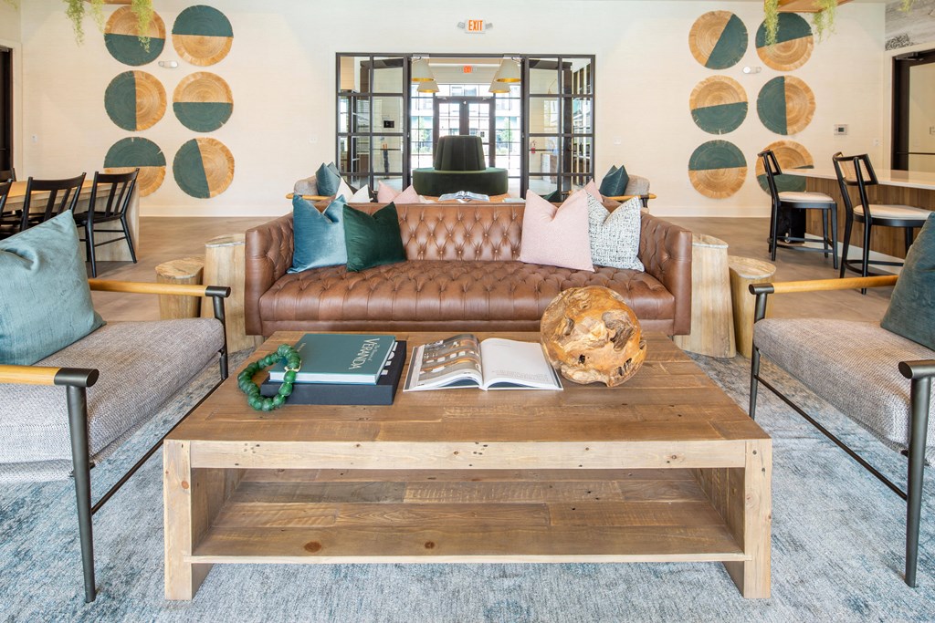 a living room with couches and a coffee table with books